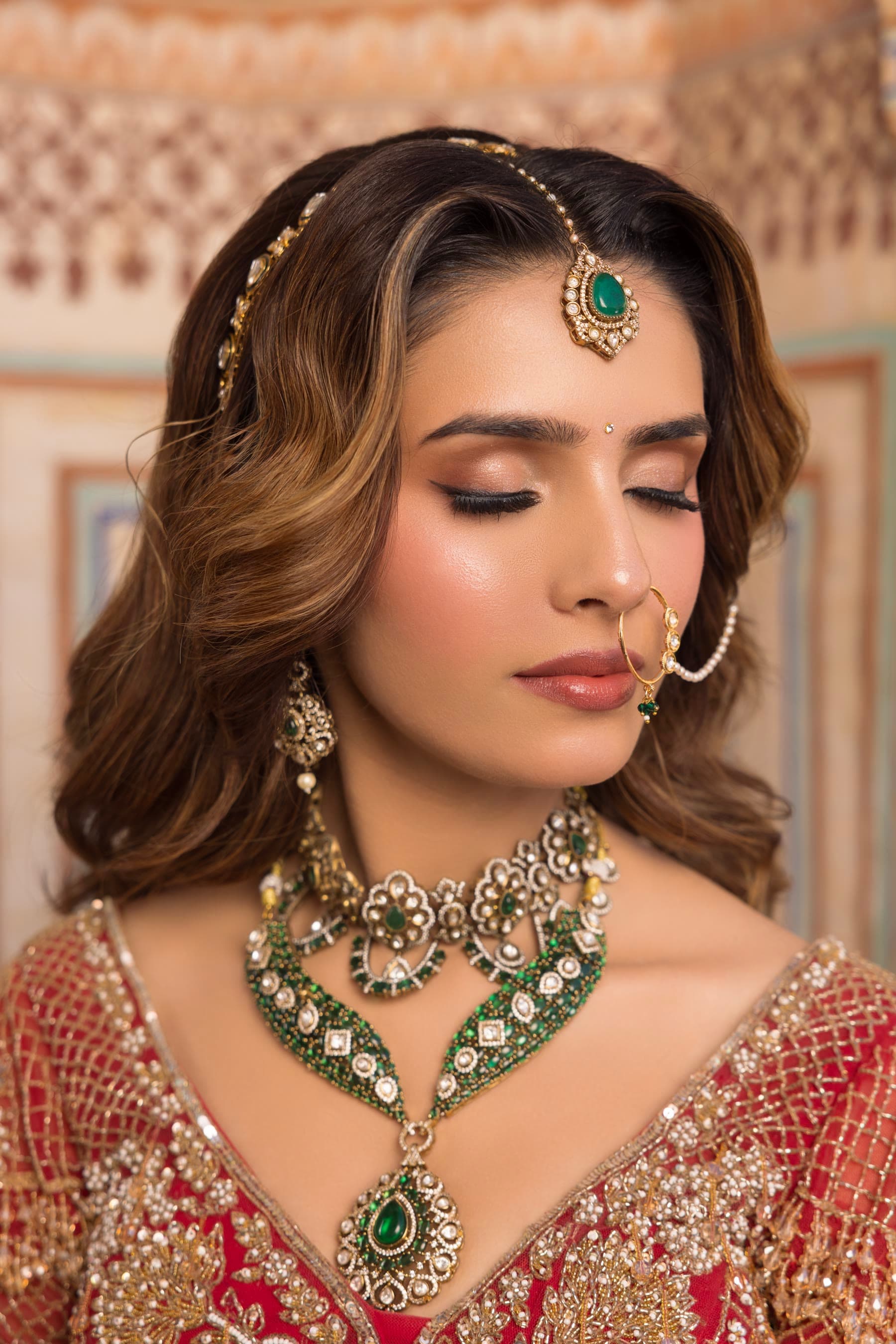 Eyes closed, liner and a soft rose lid, pearls at the neck