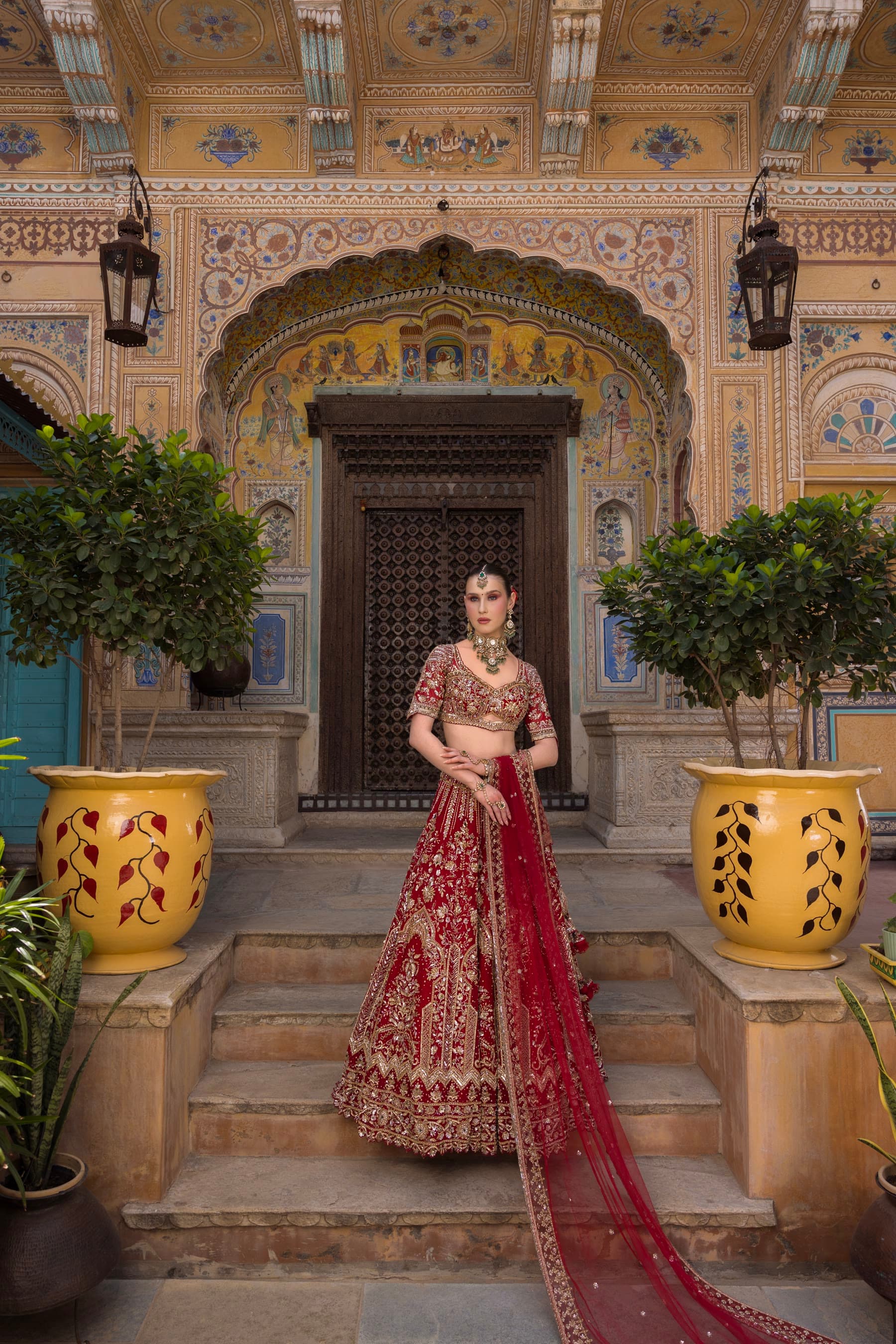 A bride on the steps, skirt spread across the stone